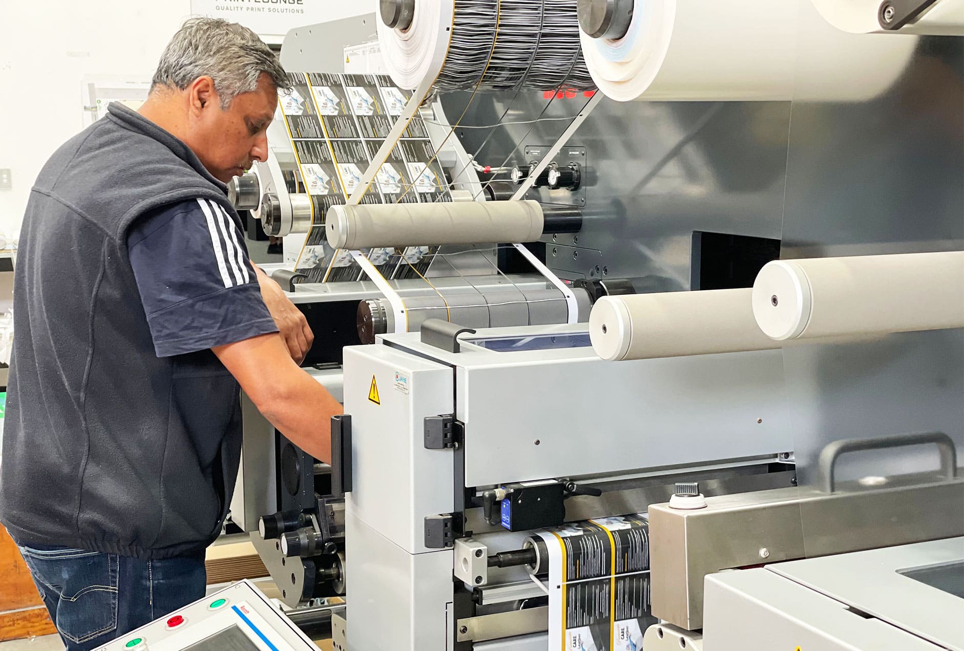 Man operating label printing machine